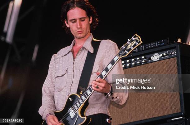 American singer, songwriter and guitarist Jeff Buckley, wearing a fine-check zip-front shirt and playing a Gibson Les Paul Custom, performs live on...