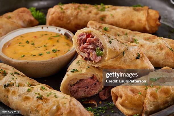 philly cheese steak egg rolls with spicy cheese dip - egg roll stock pictures, royalty-free photos & images