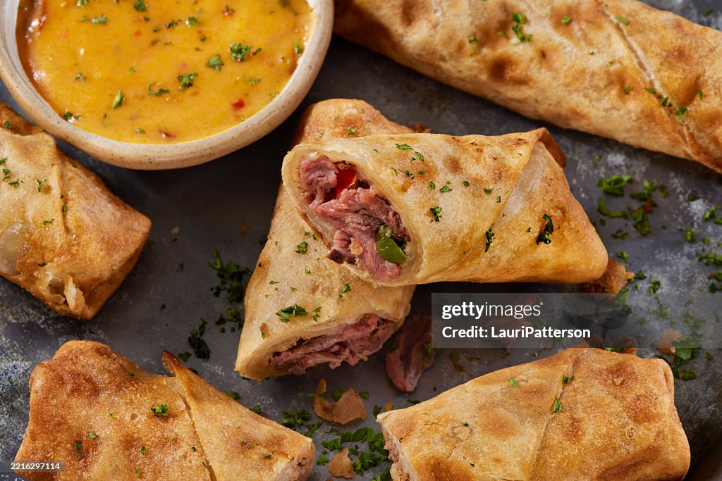 Philly Cheese Steak Egg Rolls with Spicy Cheese Dip