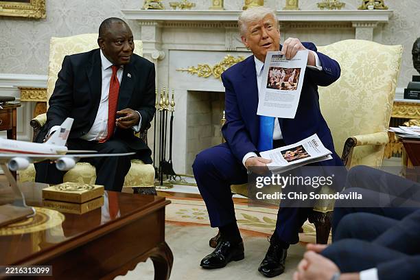 President Donald Trump holds up a printed article from "American Thinker" while accusing South Africa President Cyril Ramaphosa of state-sanctioned...