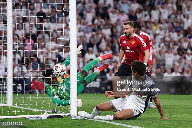 Brennan Johnson of Tottenham Hotspur scores his team's first goal past Andre Onana of Manchester United during the UEFA Europa League Final 2025...