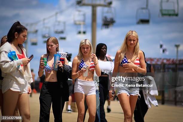 People walk on the Broadwalk on May 25, 2025 in Seaside Heights, New Jersey. Memorial Day weekend is the unofficial start of the beach season and is...