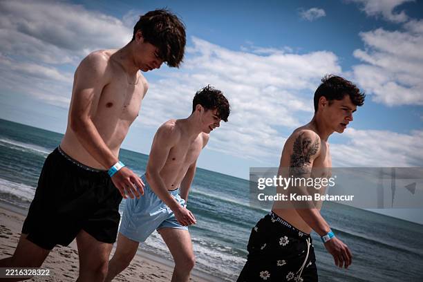 People walk on the beach on May 25, 2025 in Seaside Heights, New Jersey. Memorial Day weekend is the unofficial start of the beach season and is...