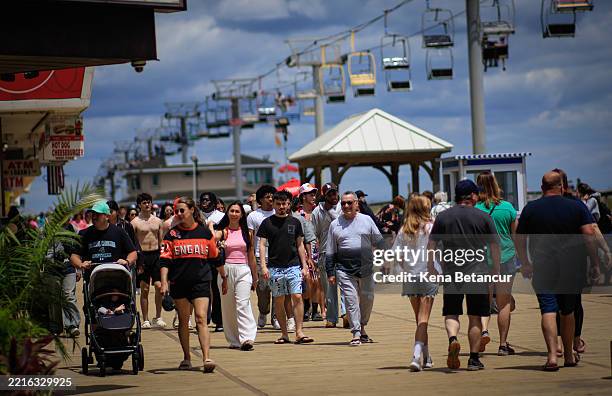 People walk on the Broadwalk on May 25, 2025 in Seaside Heights, New Jersey. Memorial Day weekend is the unofficial start of the beach season and is...