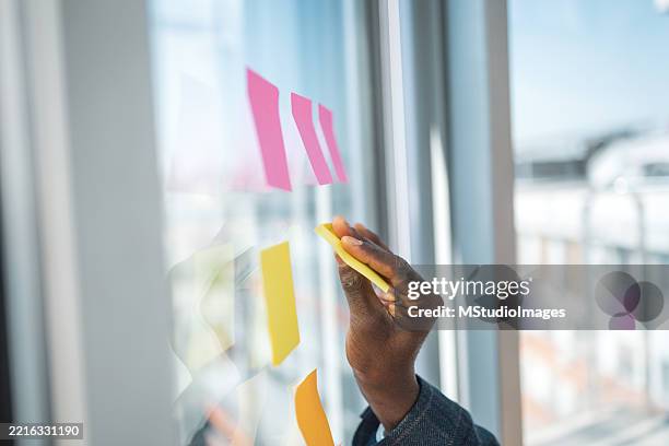 creative brainstorming session with colorful sticky notes in a modern office - força operacional imagens e fotografias de stock