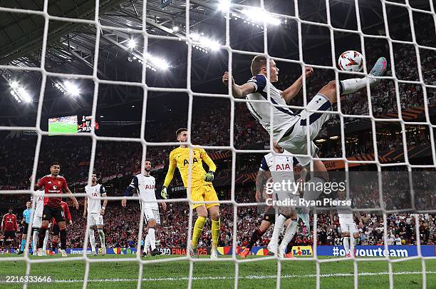 Micky van de Ven of Tottenham Hotspur makes a goal-line clearance after a header from Rasmus Hojlund of Manchester United during the UEFA Europa...