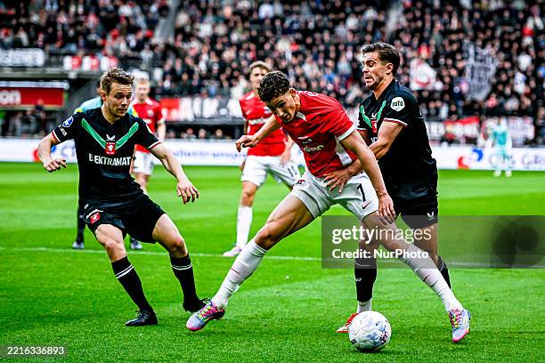 Twente midfielder Mathias Kjolo, AZ Alkmaar forward Ruben van Bommel, and FC Twente defender Bart van Rooij participate in the match between AZ and...