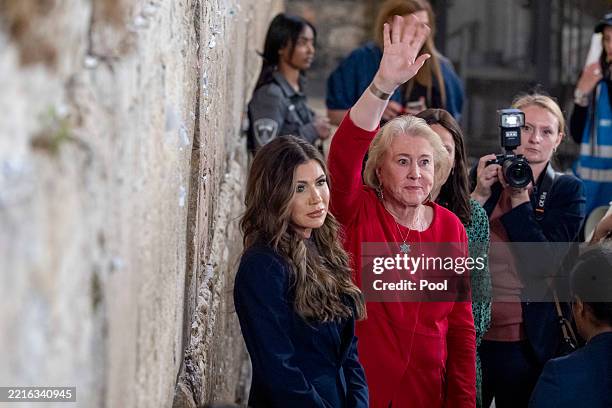 Homeland Security Secretary Kristi Noem, left, waves with Janet Huckabee after placing a note at the Western Wall, the holiest site where Jews can...