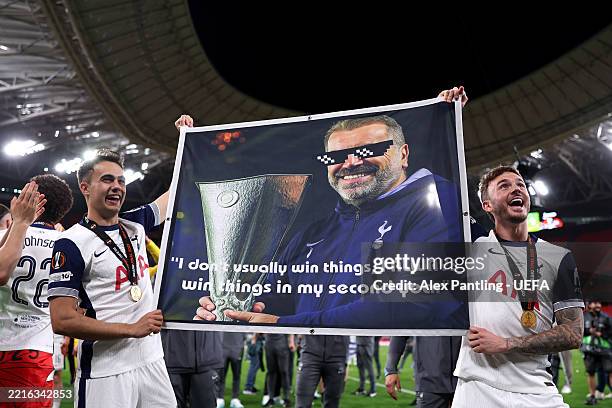 Sergio Reguilon and James Maddison of Tottenham Hotspur hold up a banner of Ange Postecoglou, Manager of Tottenham Hotspur, that reads "I don't...