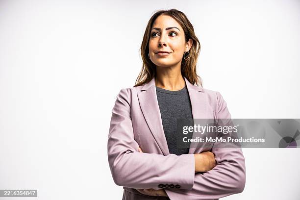 studio portrait of businesswoman smiling on white background - purple suit stock pictures, royalty-free photos & images