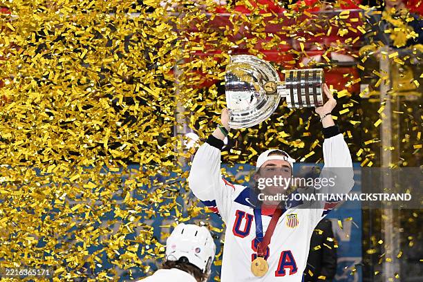 Forward Tage Thompson raises the throphy after he scored the goal for winning gold during the overtime of the IIHF Men's Ice Hockey World...