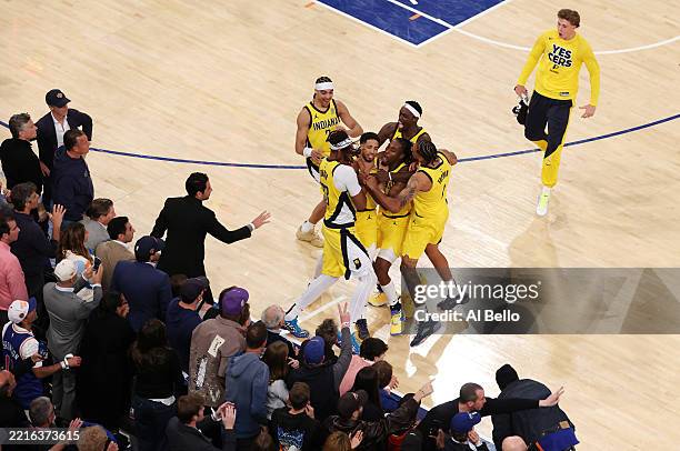 Tyrese Haliburton of the Indiana Pacers is congratulated by his teammates after scoring a game-tying basket against the New York Knicks as time...