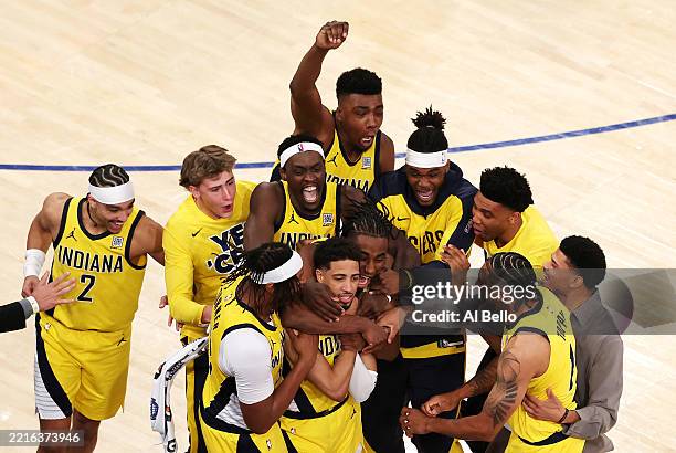 Tyrese Haliburton of the Indiana Pacers is congratulated by his teammates after scoring a game-tying basket against the New York Knicks as time...
