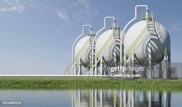 chemical storage in a grassy field - benzintank stock-fotos und bilder