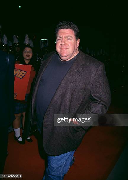 American actor and comedian George Wendt, wearing a black blazer over a dark blue crew-neck top with jeans, attends the Beverly Hills premiere of...