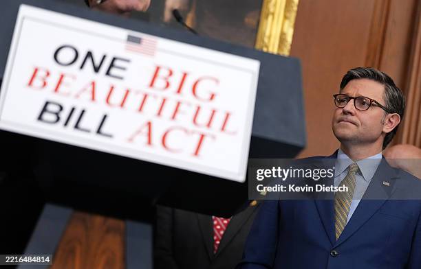 Speaker of the House Mike Johnson listens at House Homeland Security Chairman Mark Green speaks to the media after the House narrowly passed a bill...