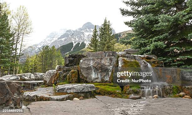 Small mini-waterfall seen at Kananaskis Village, an unincorporated community nestled in Alberta's Rockies within the Kananaskis Country park system,...