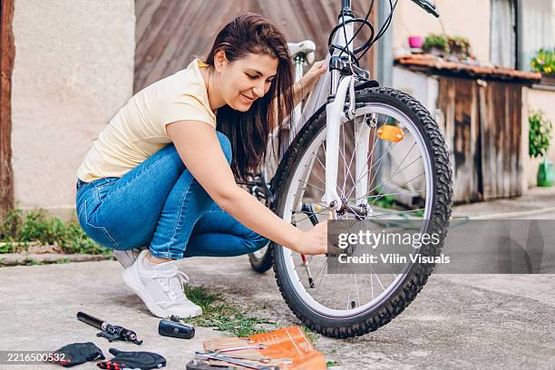 woman repairing the bicycle - brake stock pictures, royalty-free photos & images
