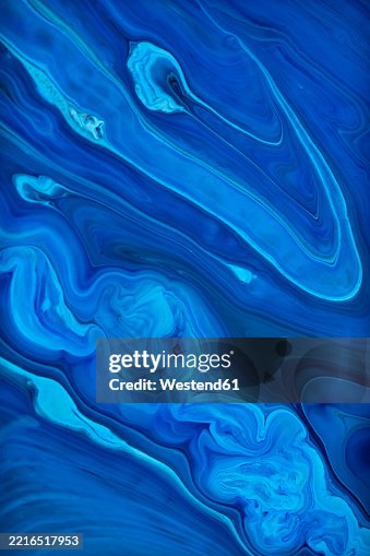 Swirling blue inks create a dynamic abstract design Swirling blue inks create a dynamic abstract design