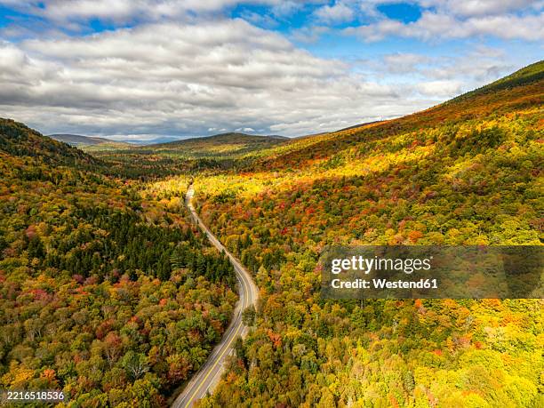 aerial view of a scenic road through fall foliage in grafton notch, maine - maine road stock pictures, royalty-free photos & images