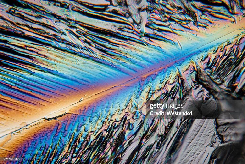 Magnified erythritol crystals display colorful patterns in an abstract macro view