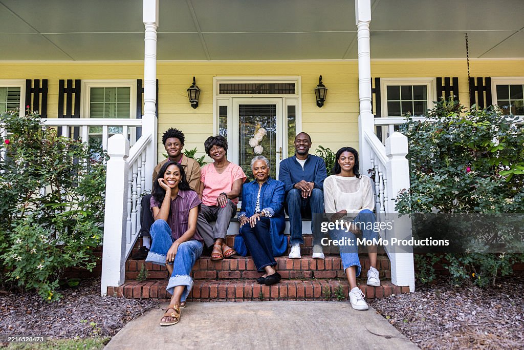 Portrait of multi-generational family in front of rural farm home