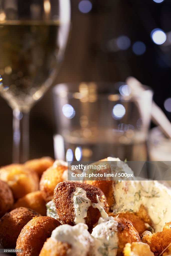 Round fried mozzarella cheese sticks under tzatziki sauce from yogurt
