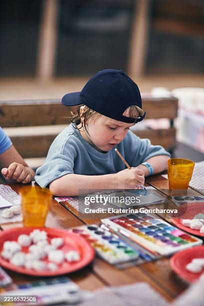 young child engaging in art activities using watercolors outside - art and craft stock pictures, royalty-free photos & images