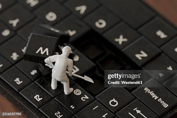 miniature figurine working on a keyboard in a 3d concept - groundbreaking shovel stock illustrations