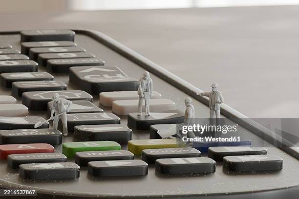 miniature workers on a remote control in a 3d conceptual scene - cleaning electronics stock illustrations