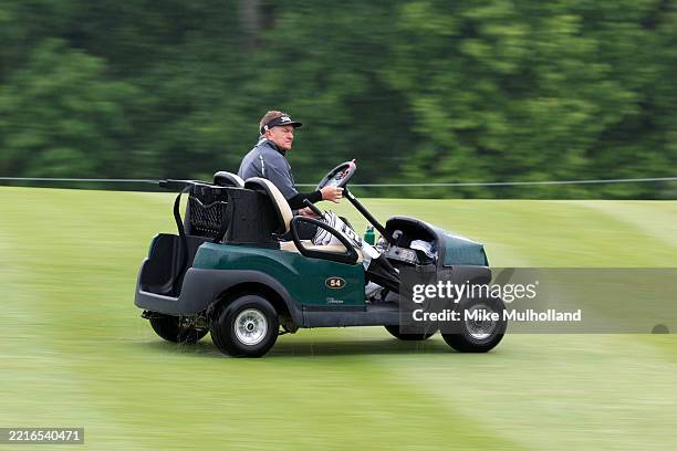 Paul Broadhurst of England rides in a golf cart as he plays the eighth hole during the first round of the Senior PGA Championship 2025 at...