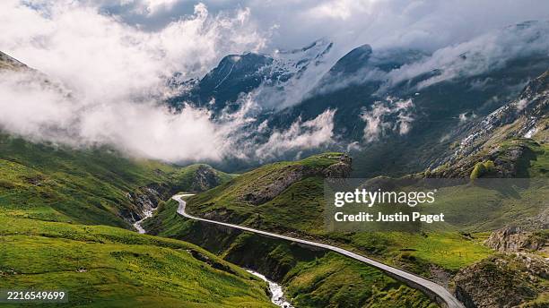 a majestic aerial/drone view of a mountain pass through the pyrenees on a bright spring morning - rock formation stock pictures, royalty-free photos & images
