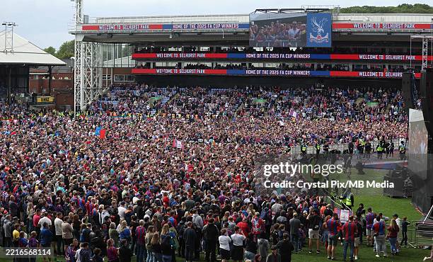 Crystal Palace fans pack Selhurst Park pitch for during the Crystal Palace FA Cup trophy parade and celebrations on May 26, 2025 in London, England.