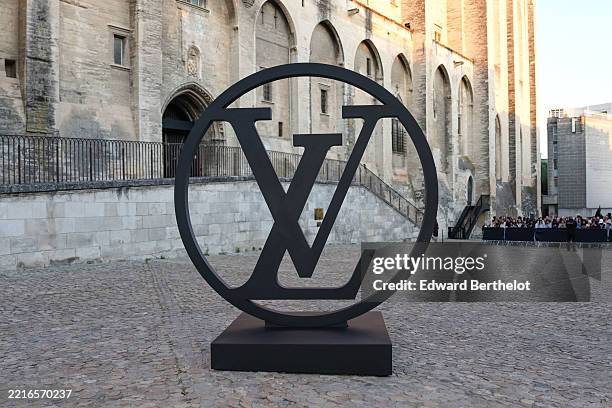 The Louis Vuitton logo is seen on the photocall backdrop in the courtyard, during the Louis Vuitton Cruise 2026 at Palais Des Papes on May 22, 2025...