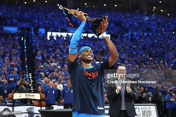 Shai Gilgeous-Alexander of the Oklahoma City Thunder accepts the MVP Michael Jordan Trophy prior to a game against the Minnesota Timberwolves in Game...