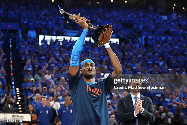 Shai Gilgeous-Alexander of the Oklahoma City Thunder accepts the MVP Michael Jordan Trophy prior to a game against the Minnesota Timberwolves in Game...