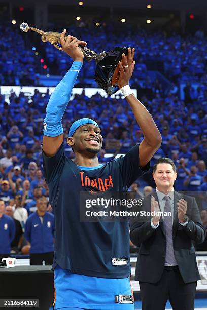 Shai Gilgeous-Alexander of the Oklahoma City Thunder accepts the MVP Michael Jordan Trophy prior to a game against the Minnesota Timberwolves in Game...