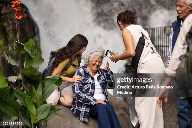 multigenerational family spending time in the park - family time stock pictures, royalty-free photos & images