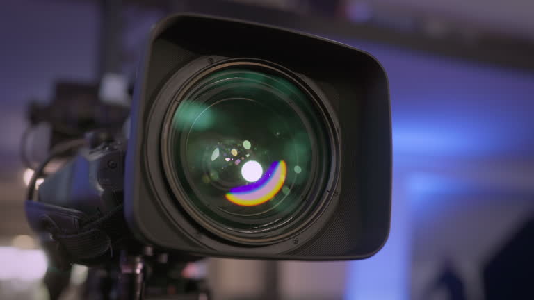 https://media.gettyimages.com/id/2216636218/video/close-up-view-od-broadcast-camera-lens-reflecting-lights-in-the-tv-studio.jpg?b=1&s=640x640&k=20&c=xbFnjCjrry7zE8Y2vyFCSZ3DK4Kgofm2Hd8QLxQMhno=