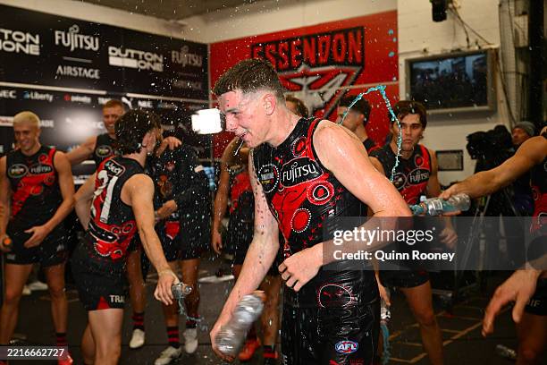 Angus Clarke of the Bombers is showered in energy drink by team mates after the round 11 AFL match between Essendon Bombers and Richmond Tigers at...