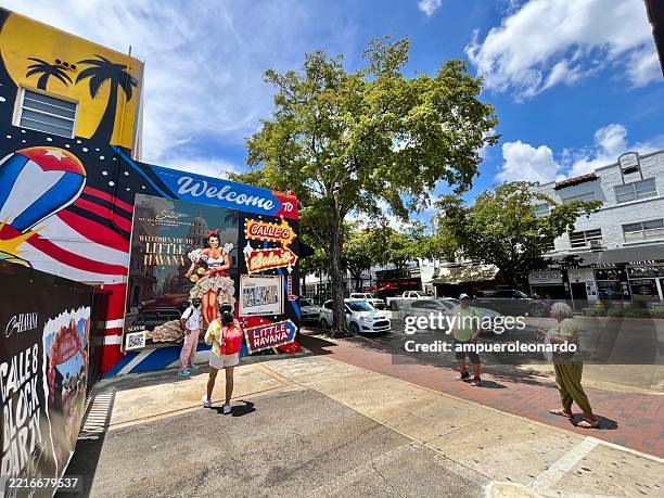 tourists admiring little havana's vibrant street art in miami, florida - latin music stock pictures, royalty-free photos & images