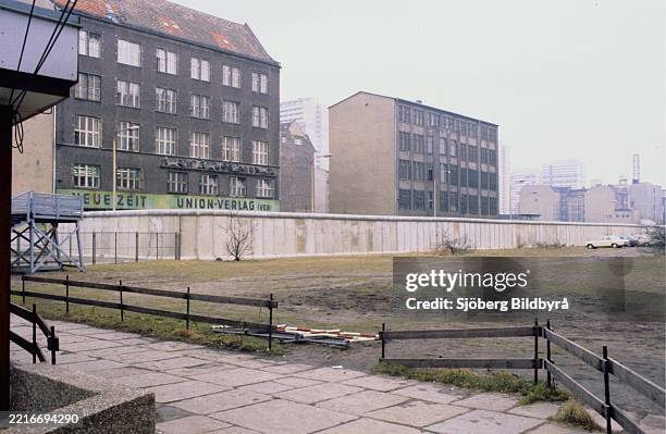 The Berlin Wall. A guarded concrete barrier that encircled West Berlin from 1961 to 1989, separating it from East Berlin and East Germany. The...