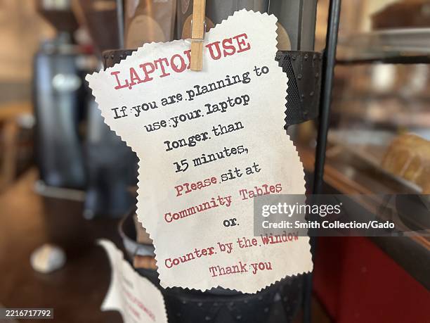 I'm Using This Computer Sign Laptop usage sign posted inside a coffee shop, reminding patrons to ...