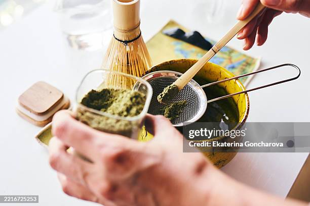 preparing matcha tea with traditional tools in a bright setting - making tea stock pictures, royalty-free photos & images