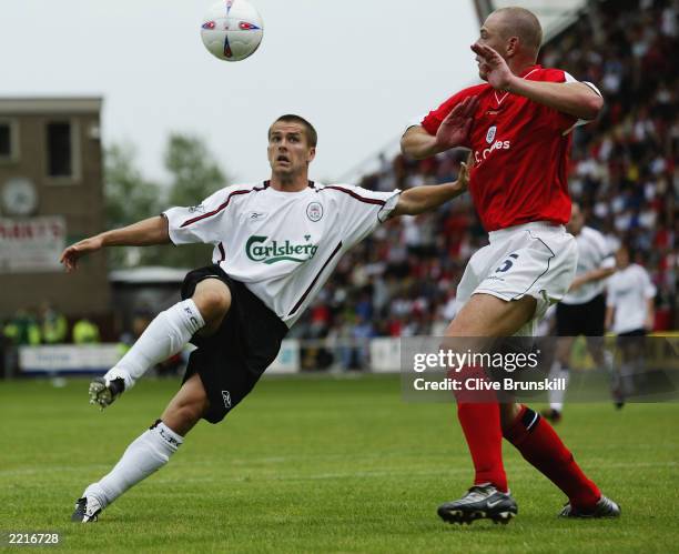 Michael Owen of Liverpool lifts the ball over Richard Walker of Crewe Alexandra head during the Pre-Season Friendly match held on July 19, 2003 at...