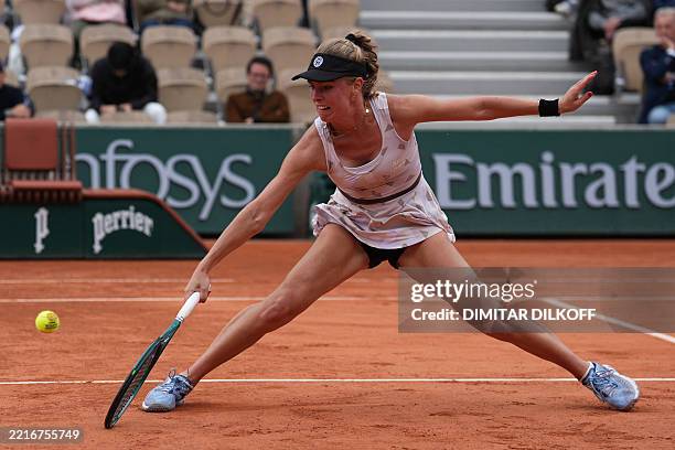 Poland's Magdalena Frech plays a backhand return to Tunisia's Ons Jabeur during their women's singles match on day 3 of the French Open tennis...