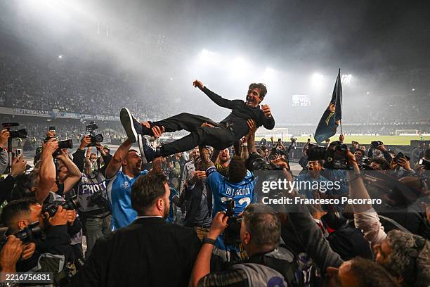 Antonio Conte, Head Coach of Napoli, is lifted by his team following victory in the Serie A match between Napoli and Cagliari at Stadio Diego Armando...