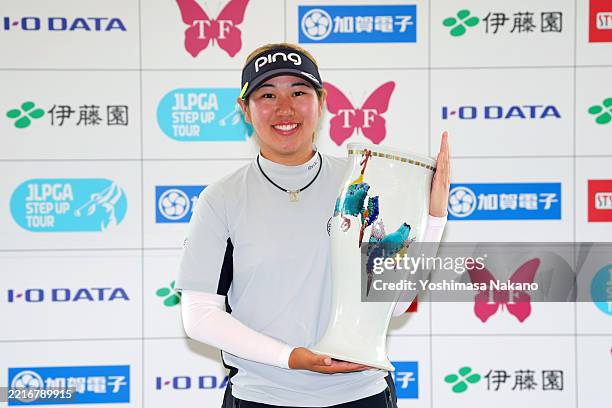 Reina Maeda of Japan poses with the trophy after winning the tournament which has been shortened to 36- hole stroke play after a bear was witnessed...