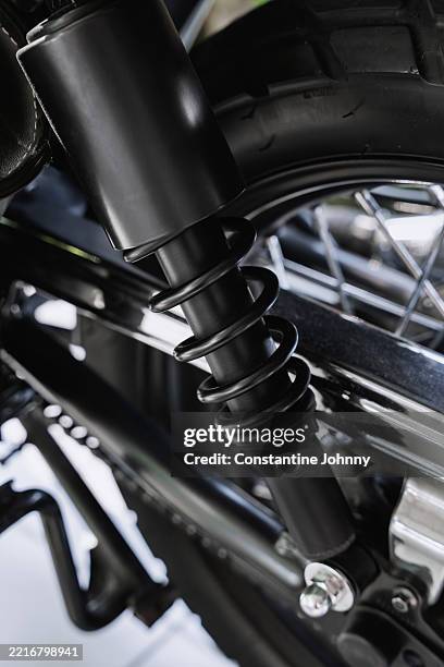 motorcycle shock absorber and spring - amortiguador mecánico fotografías e imágenes de stock