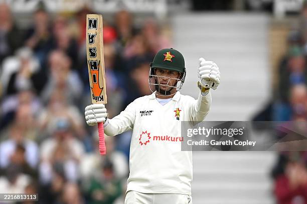 Sean Williams of Zimbabwe celebrates reaching his half century during day three of the Rothesay Test Match between England and Zimbabwe at Trent...
